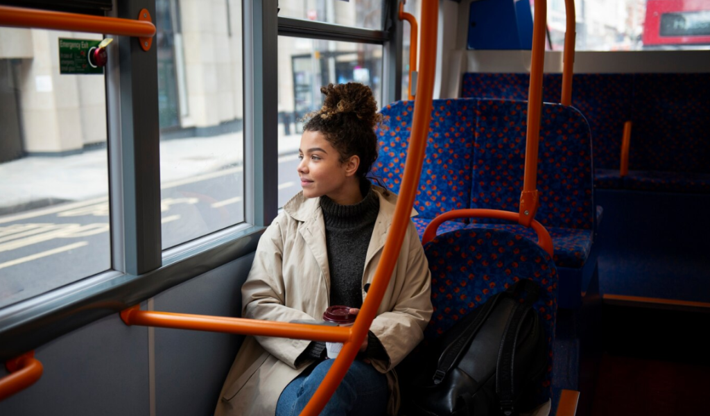 A women looking outside the window while sitting in a tram