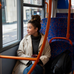 A women watching out of a train window while commuting to work practicing mindfulness