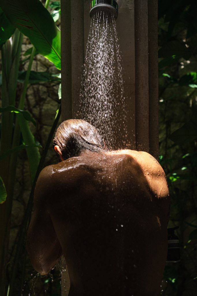 a man taking a shower in nature